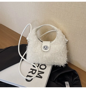 Close-up of white plush faux fur bag featuring a silver metal twist lock and slim strap