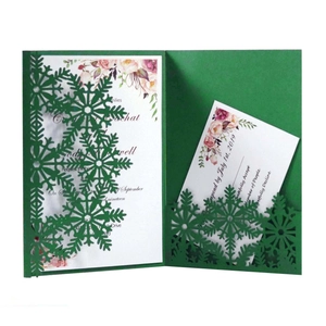 Laser-cut dark green snowflake invitation set with elegant floral inner cards