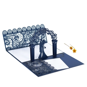Detail of laser-cut lace border and 3D pop-up floral arch silhouette on navy wedding card