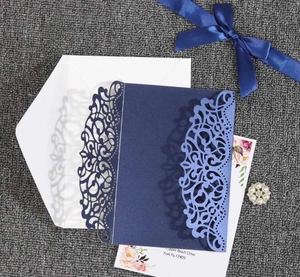 Navy blue laser-cut wedding invitation set with floral insert and lace-style sleeve