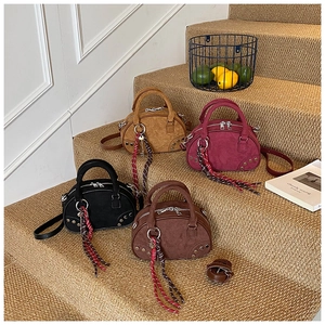 Group shot of matte suede Boston bags in four colors with vintage rivet details