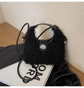 Detail of black faux fur handbag with silver twist lock and adjustable shoulder strap
