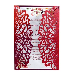 Detail of red laser-cut hollow wedding invitation card with floral interior insert