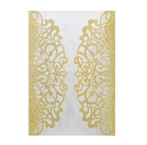 Detailed view of golden laser-cut wedding invitation with glitter finish and floral pattern