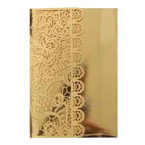 Detail of gold laser-cut hollow lace wedding invitation with intricate floral patterns