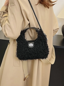 Women's black faux shearling handbag with metallic twist lock and versatile strap