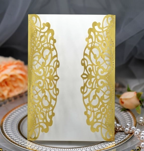 Detailed laser-cut pattern on gold hollow invitation card for luxury weddings