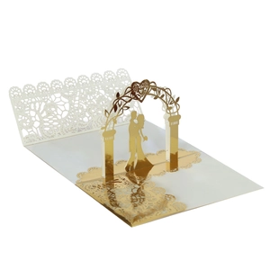 Detail of 3D pop-up wedding invitation featuring gold foil lace and romantic couple silhouette