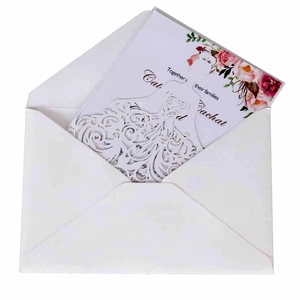 Laser-cut floral wedding invitation card with pink roses and elegant white envelope