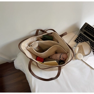 Top view of large canvas tote interior showing zipper pockets and spacious capacity