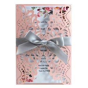 Laser-cut pink wedding invitation card set with elegant floral inner page and grey ribbon bow