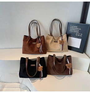 Minimalist large tote bags in four retro colors displayed on steps with plush bear charms