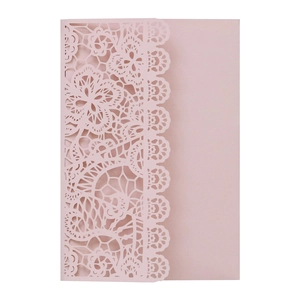 Close-up of laser-cut floral pattern on pearlescent pink wedding invitation card