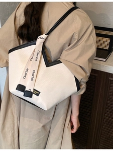Minimalist large capacity tote bag in cream and black with decorative ribbon strap
