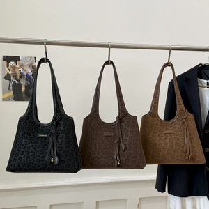 Three leopard print tote bags in black, dark brown, and caramel with stylish shoulder straps