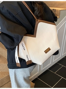 Minimalist herringbone tote bag with brown leather trim and stylish fabric straps