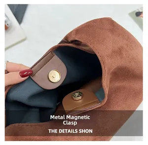Detail view of the brown suede tote bag featuring a premium gold magnetic snap closure