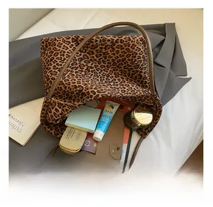 Macro shot of large leopard print tote bag showing spacious interior with daily items