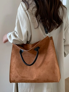 Borsa tote leopardata in pelle scamosciata con manici neri vista su modella