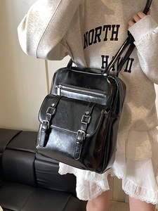 Glossy black vintage backpack with decorative buckles and silver hardware for women