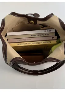 Top view of spacious interior of canvas and brown leather tote bag showing large capacity