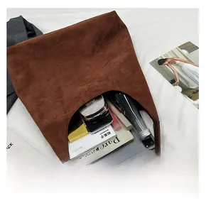 Deep brown suede tote bag showing large storage capacity for tablets and daily items