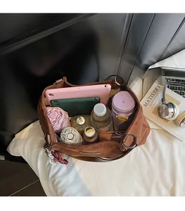 Large coffee suede tote bag showing spacious interior with tablet, bottle, and umbrella