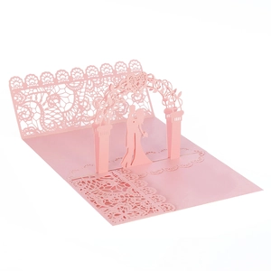 Detail of pink 3D pop-up card showing laser-cut couple under flower arch