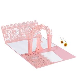 Close-up of laser-cut lace 3D pop-up wedding card featuring romantic kissing couple