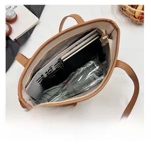 Detailed view of the brown tote bag interior showing large capacity for books and daily items