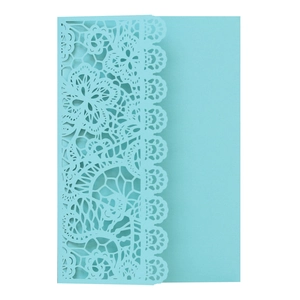 Detail of light blue laser-cut lace floral pattern on wedding invitation card