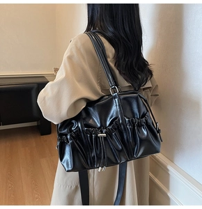 Gros plan sur un cabas rétro noir avec détails de cordon et texture en cuir souple