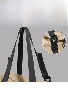 Detail view of durable black nylon webbing handle and adjustable buckle on travel tote