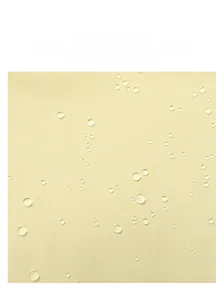 Macro detail of water-resistant yellow nylon fabric with visible droplets on tote bag