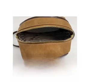 Detail view of the vintage leopard backpack interior with striped lining and gold zipper