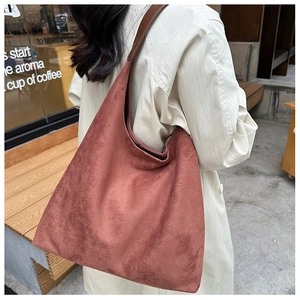 Close-up of the brick red matte suede fabric texture on this large tote bag for women