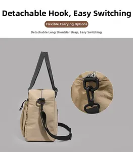 Detail of detachable black plastic hook and durable nylon strap on khaki travel tote