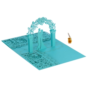 Macro view of blue 3D pop-up wedding invitation featuring laser-cut couple and heart arch