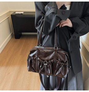 Vue détaillée du sac cabas vintage en cuir marron avec des poches plissées pratiques