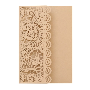 Detailed close-up of cream lace laser-cut wedding invitation card with floral patterns
