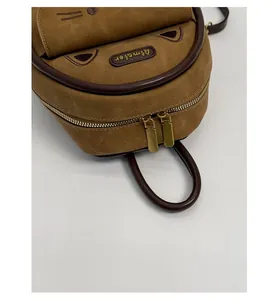 Close-up of smooth dual golden metal zippers on vintage leopard kitten backpack