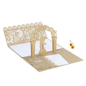 Macro detail of laser-cut 3D wedding card with champagne gold silhouettes and intricate patterns