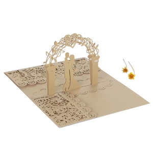 Macro view of laser-cut 3D wedding card showing a couple under a heart vine archway