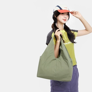 Detail view of the large olive green hobo tote bag featuring lightweight pleated nylon fabric