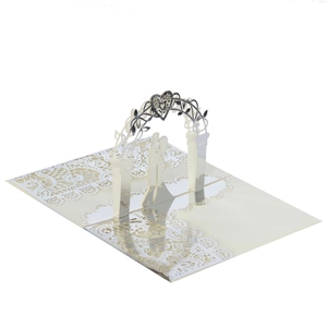 Detail view of 3D pop-up wedding card with laser-cut lace and romantic couple silhouette