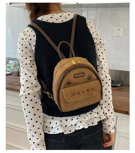 Close-up of a brown leopard cat-shaped mini backpack with 3D ears and embroidery