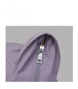 Close-up of durable silver metal zipper and embossed puller on purple tote bag detail