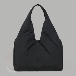 Close-up of a large black tote bag featuring lightweight pleated fabric for casual daily use