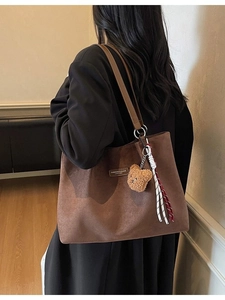 Large dark brown suede tote bag with leather strap and bear charm accessory