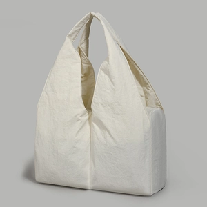 Close-up of cream-white large tote bag with textured crinkle fabric and spacious design